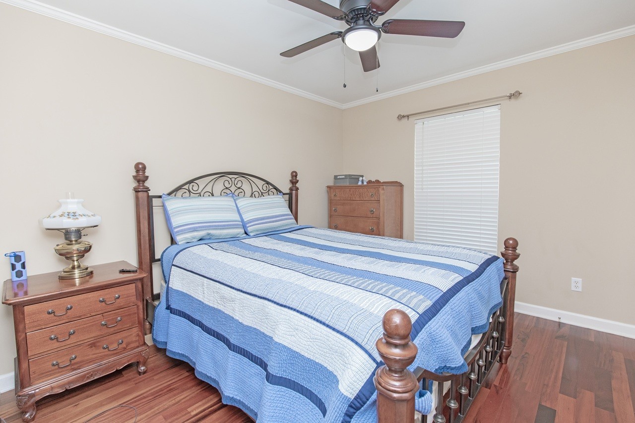 5012 John Hagar Road Hermitage, TN 37076 - Photo 28 of 45 a bedroom with a bed and a chandelier