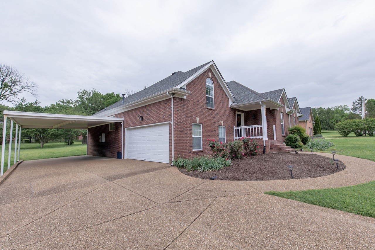 5012 John Hagar Road Hermitage, TN 37076 - Photo 3 of 45 a front view of a house with a yard and garage