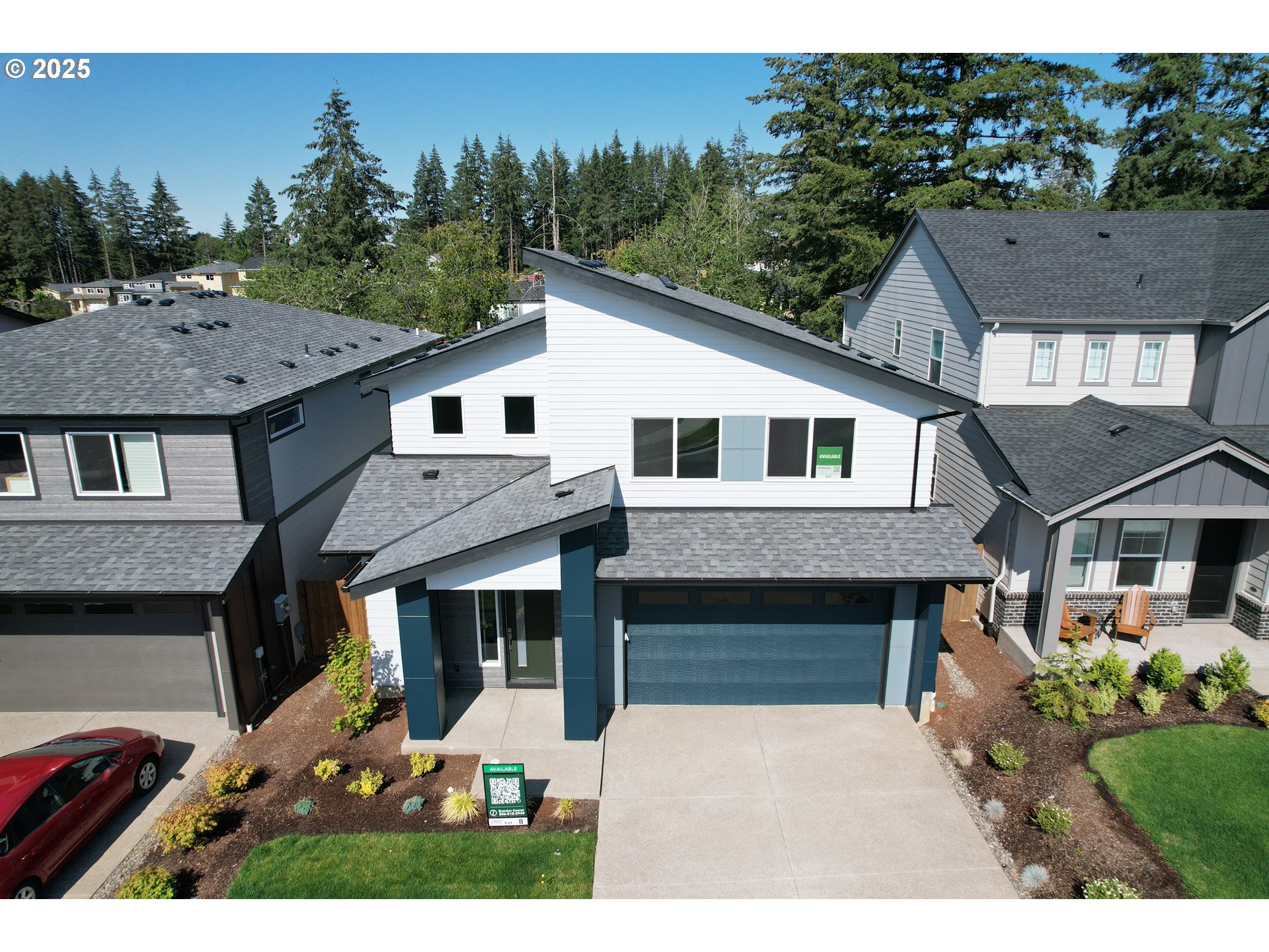 a aerial view of a house with yard and green space
