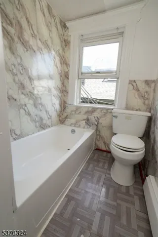 a bathroom with a toilet and a bathtub