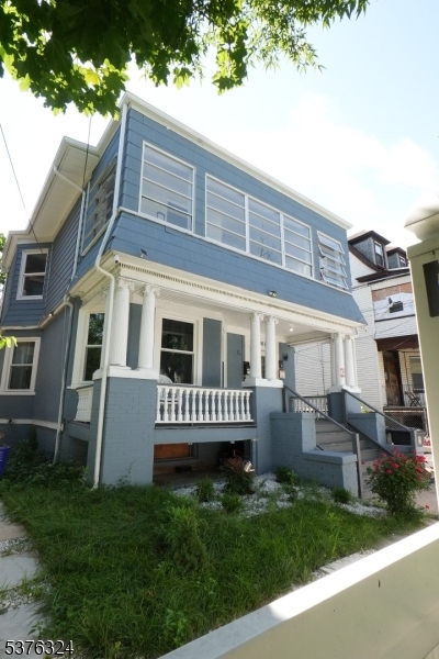 26 Treacy Avenue, Unit 1 Newark, NJ 07108 - Photo 18 of 18 a front view of a house with a garden