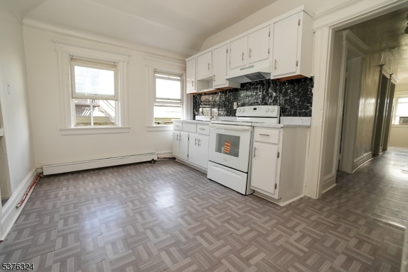 26 Treacy Avenue, Unit 1 Newark, NJ 07108 - Photo 2 of 18 a kitchen with stainless steel appliances granite countertop a stove a sink and a refrigerator