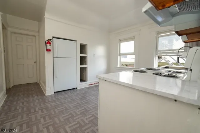 a kitchen with kitchen island a counter top space a sink and appliances