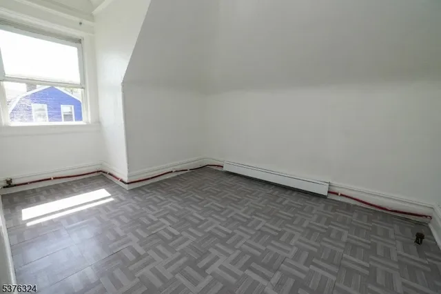a view of a room with wooden floor and fan