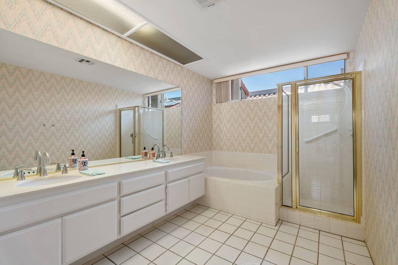 36 Colonial Drive Rancho Mirage, CA 92270 - Photo 20 of 36 a bathroom with a bathtub a shower a sink and a mirror