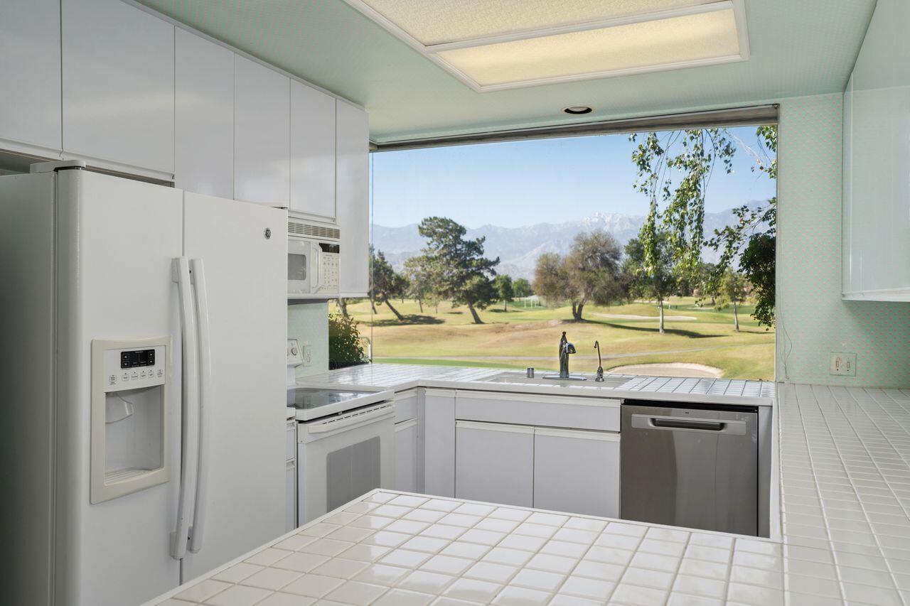 36 Colonial Drive Rancho Mirage, CA 92270 - Photo 2 of 36 a kitchen with stainless steel appliances a stove a sink and a refrigerator