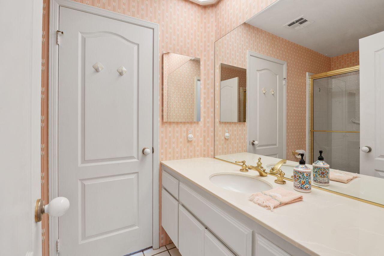 36 Colonial Drive Rancho Mirage, CA 92270 - Photo 23 of 36 a bathroom with a granite countertop sink and a mirror