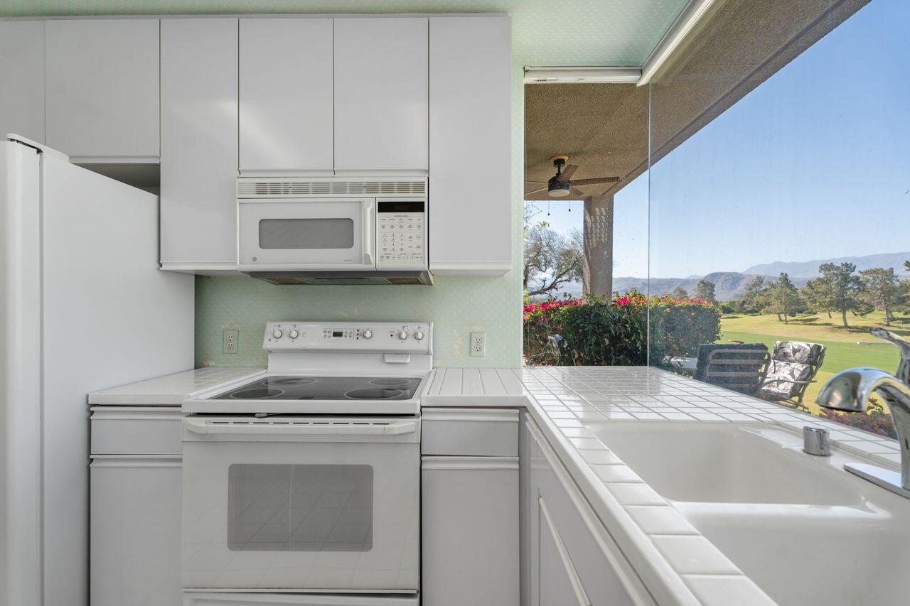 36 Colonial Drive Rancho Mirage, CA 92270 - Photo 8 of 36 a kitchen with stainless steel appliances granite countertop a sink and a stove