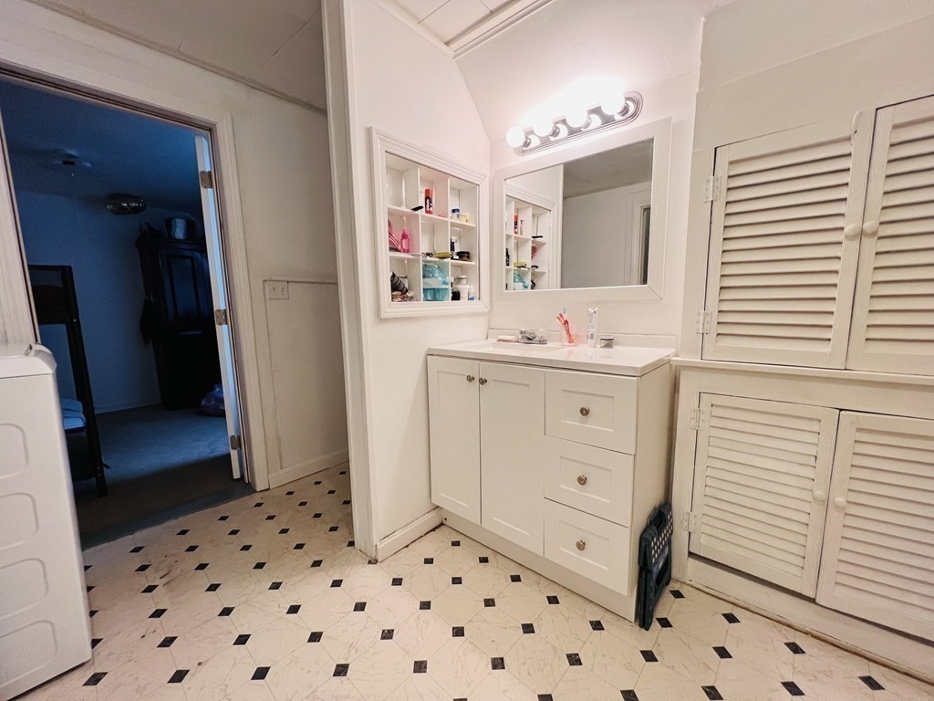 72 Oak Street Middleboro, MA 02346 - Photo 30 of 42 a bathroom with a sink a mirror and a shower