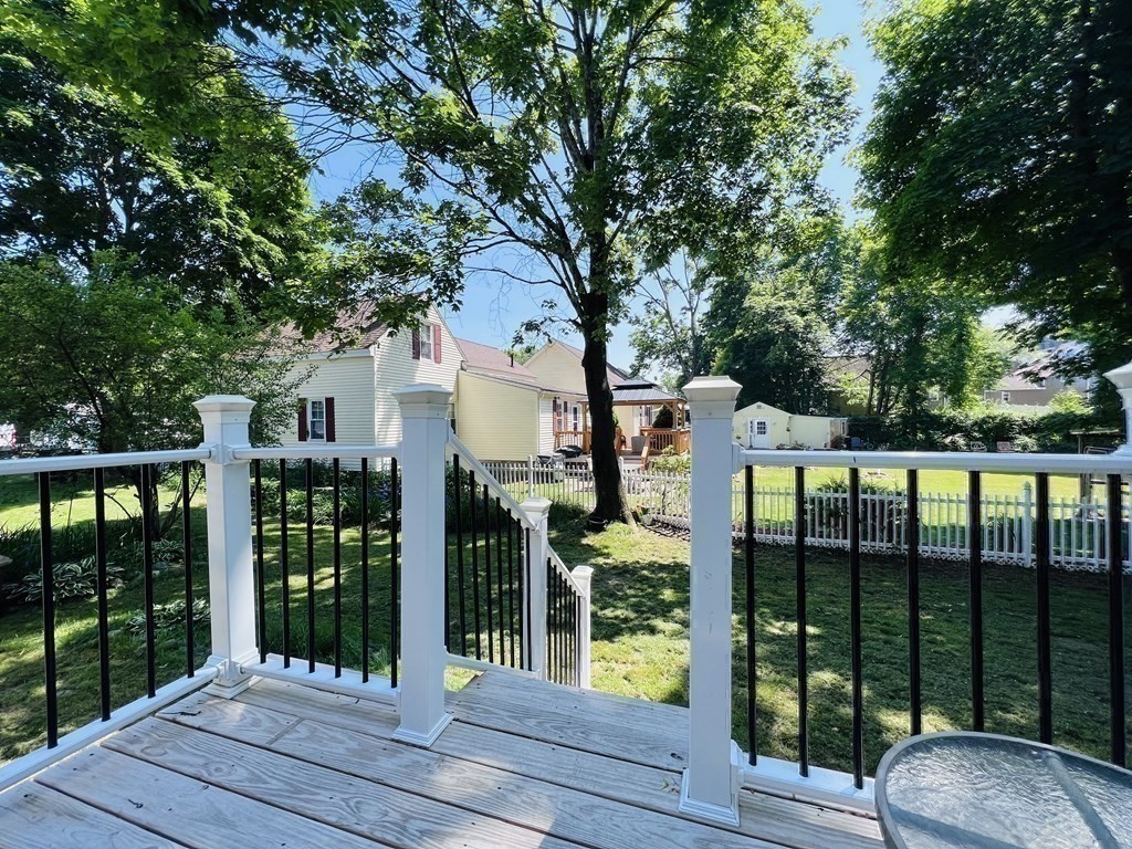 72 Oak Street Middleboro, MA 02346 - Photo 37 of 42 a view of a brick house with large windows and a large tree