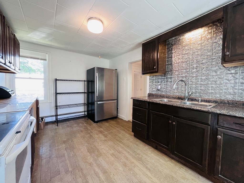 72 Oak Street Middleboro, MA 02346 - Photo 5 of 42 a kitchen with granite countertop a refrigerator and a sink