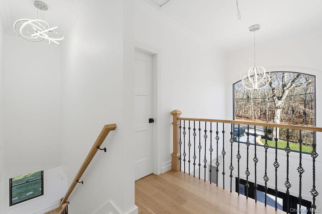 768 Bridgehampton Sag Harbor Bridgehampton, NY 11932 - Photo 27 of 35 Stairs featuring a chandelier and wood finished floors