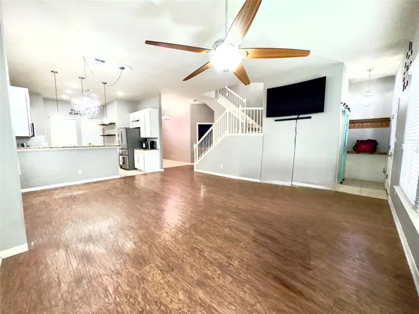 a view of a livingroom with kitchen and fireplace