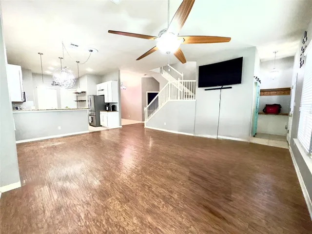 a view of a livingroom with kitchen and fireplace