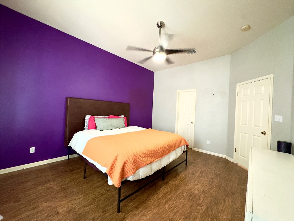 401 Witte Road Kyle, TX 78640 - Photo 4 of 33 a bedroom with a bed and a chandelier