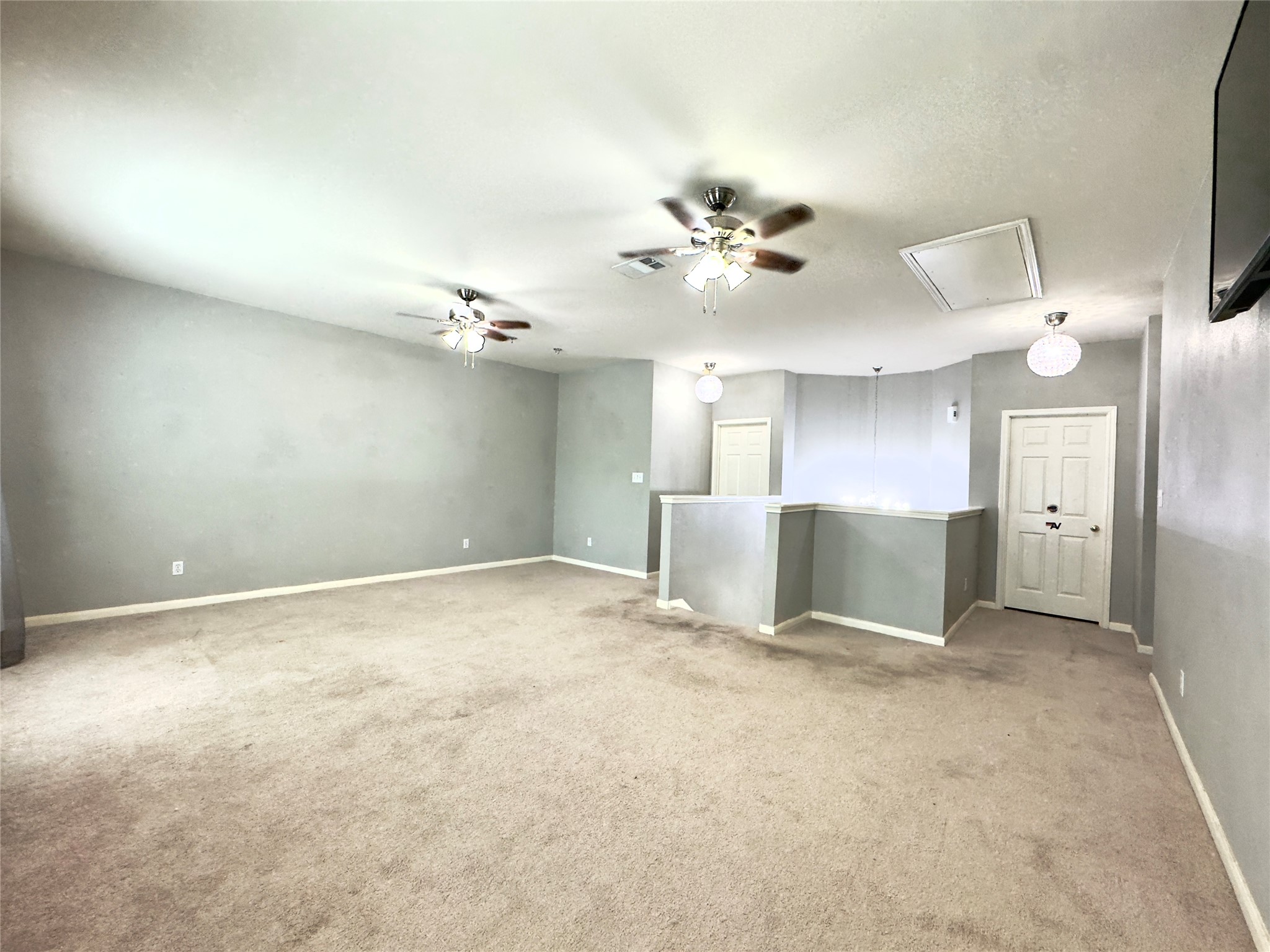 401 Witte Road Kyle, TX 78640 - Photo 10 of 33 a view of a big room with a chandelier fan and windows