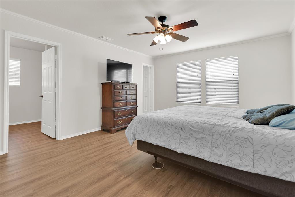 3011 Hickory Ridge Melissa, TX 75454 - Photo 21 of 30 Primary bedroom featuring wood-finish flooring, white walls, and crown molding
