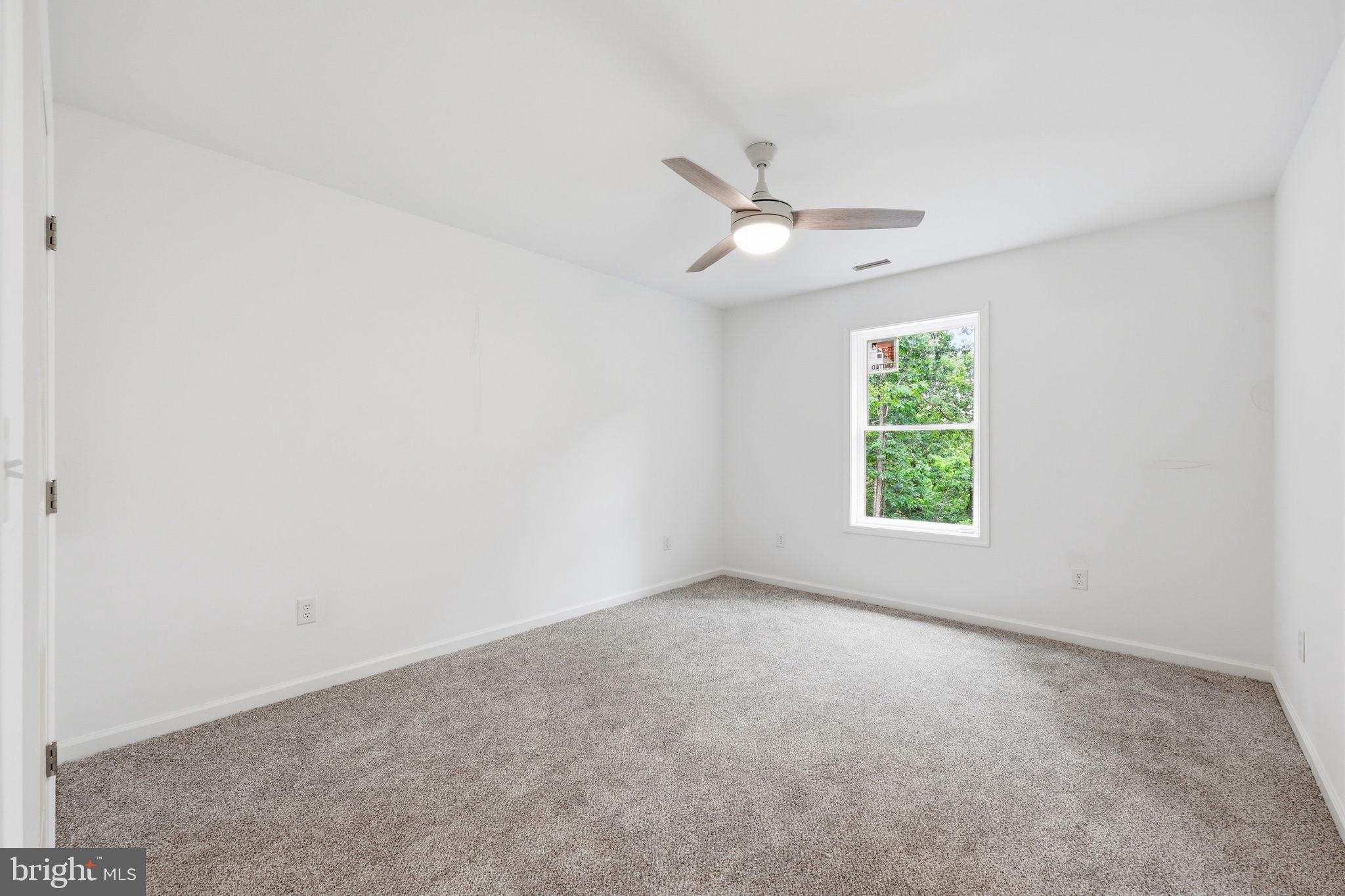 10339 Back Creek Valley Road Hedgesville, WV 25427 - Photo 34 of 48 an empty room with a window and ceiling fan