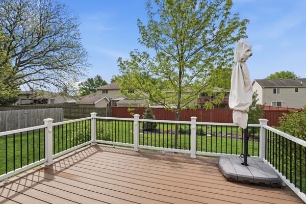 1547 West 99th Avenue Crown Point, IN 46307 - Photo 18 of 21 a view of a deck with wooden floor and fence with a large garden