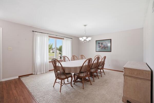 1547 West 99th Avenue Crown Point, IN 46307 - Photo 2 of 21 a view of a dining room with furniture window and wooden floor