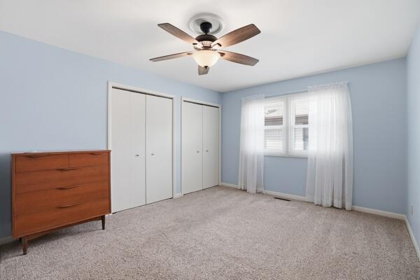 1547 West 99th Avenue Crown Point, IN 46307 - Photo 8 of 21 a view of an empty room with cabinet and a ceiling fan