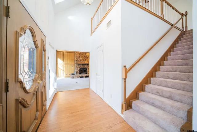 a living room with a fireplace and a large window
