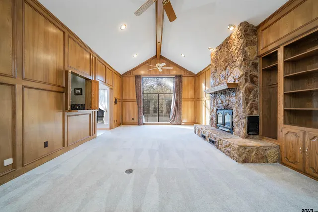 a view of empty room with a fireplace