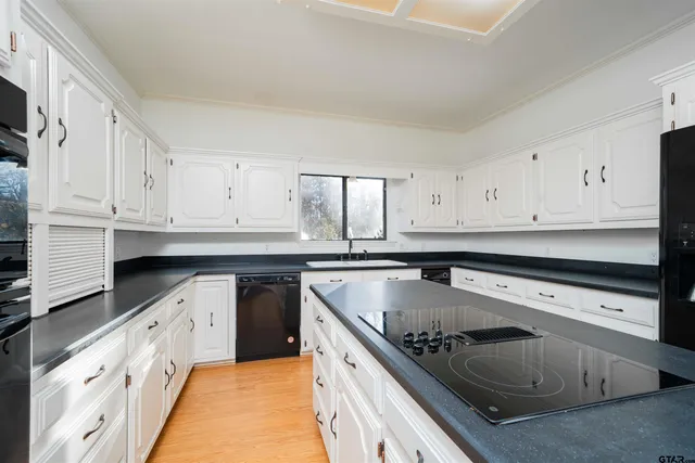 a view of an empty room with chandelier