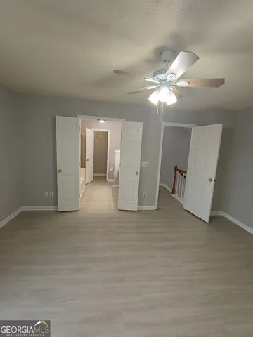 a view of a livingroom with a ceiling fan window and a chandelier