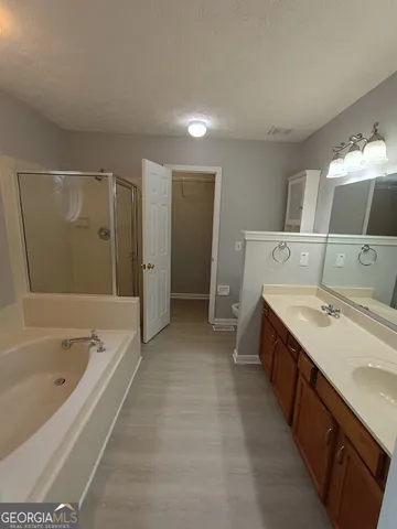 a bathroom with a tub sink and mirror