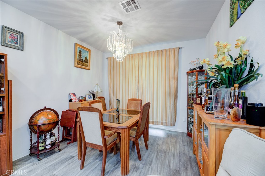 11 Lilac Lane Compton, CA 90221 - Photo 11 of 49 a dining room with furniture and wooden floor