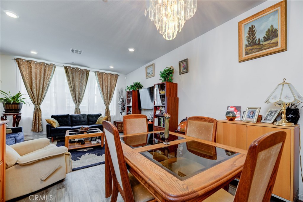11 Lilac Lane Compton, CA 90221 - Photo 13 of 49 a kitchen with a table chairs and a refrigerator