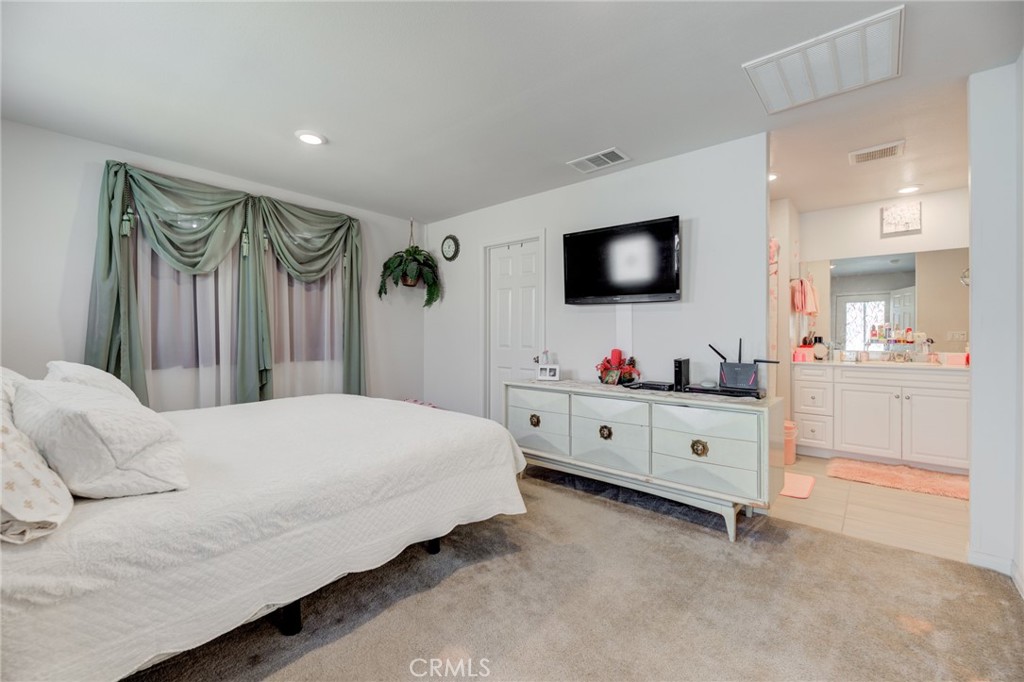 11 Lilac Lane Compton, CA 90221 - Photo 26 of 49 a bedroom with a bed and a flat screen tv