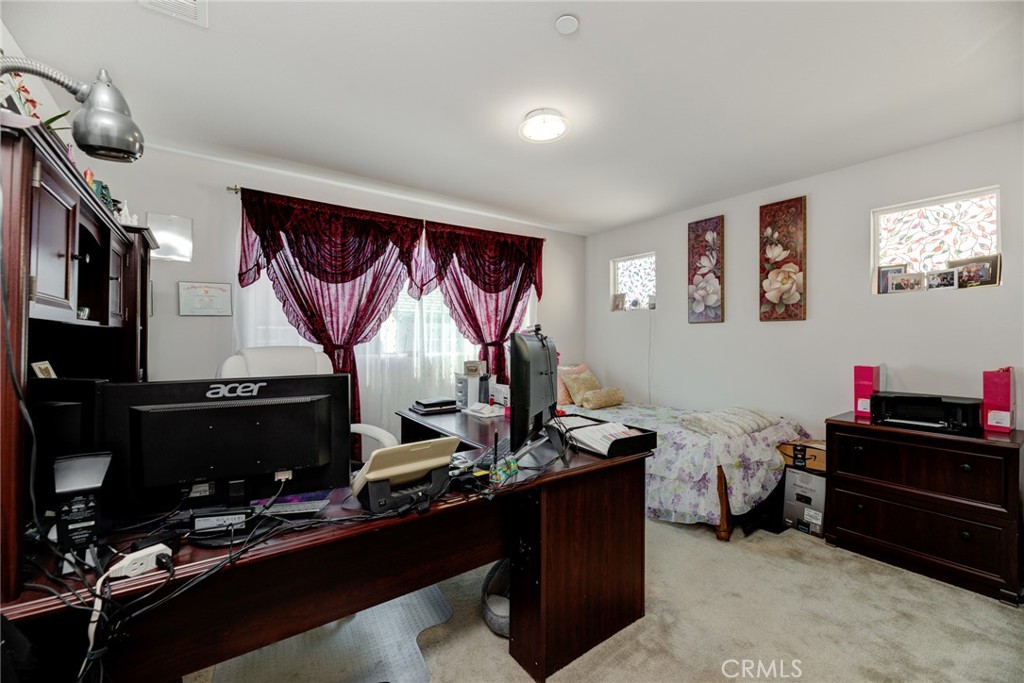 11 Lilac Lane Compton, CA 90221 - Photo 33 of 49 a room with gym equipment and a flat screen tv