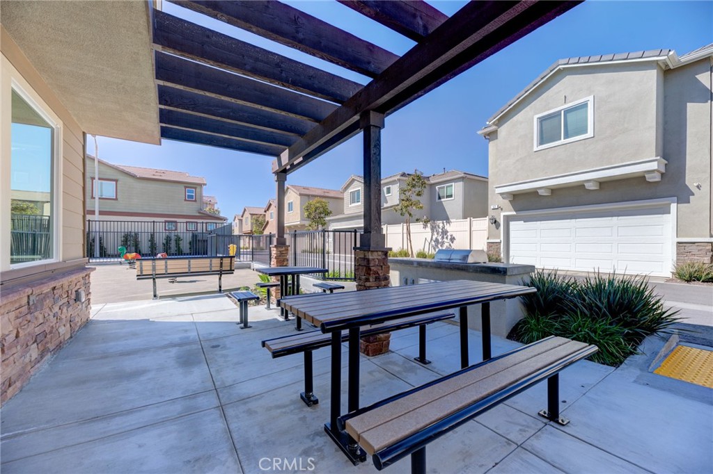 11 Lilac Lane Compton, CA 90221 - Photo 42 of 49 a view of a patio with table and chairs potted plants with wooden floor and fence