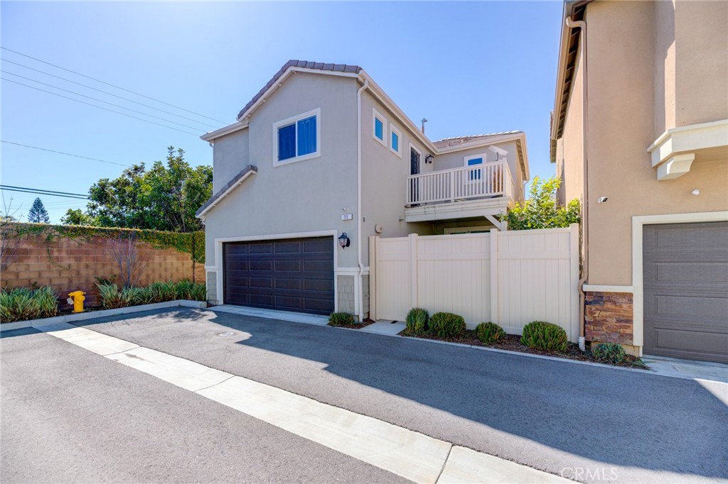 11 Lilac Lane Compton, CA 90221 - Photo 5 of 49 a front view of a house with a yard and garage