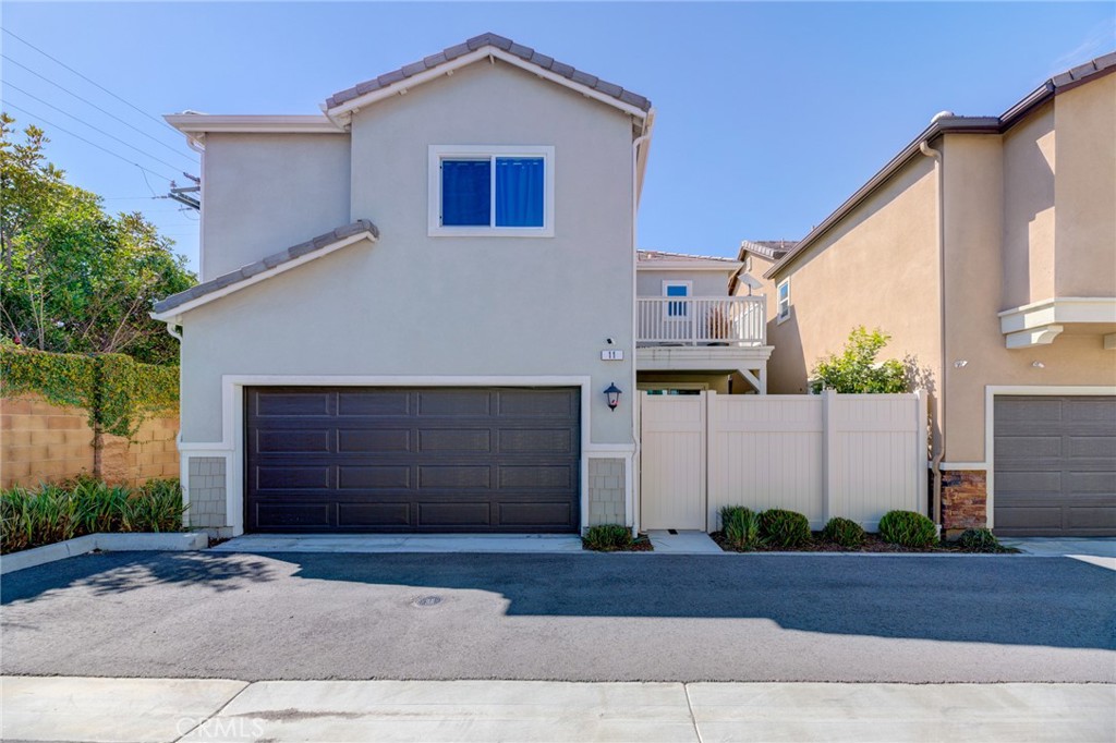 11 Lilac Lane Compton, CA 90221 - Photo 6 of 49 a front view of a house with a yard and garage