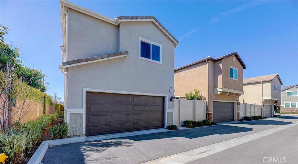 11 Lilac Lane Compton, CA 90221 - Photo 7 of 49 a front view of a house with a garage