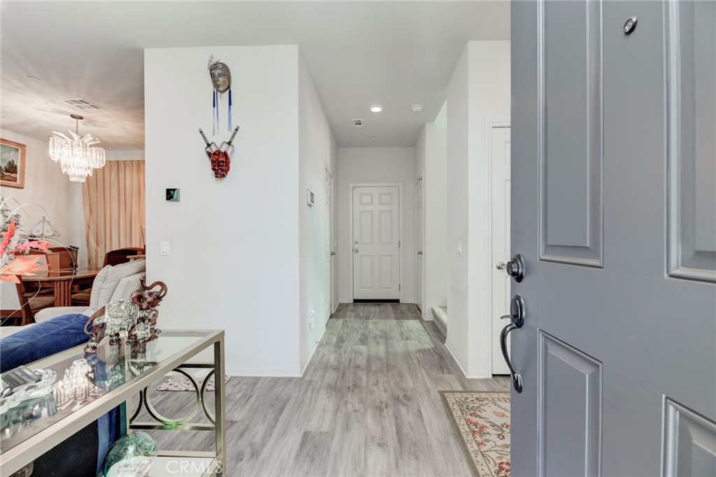 11 Lilac Lane Compton, CA 90221 - Photo 8 of 49 a view of a hallway with wooden floor and furniture