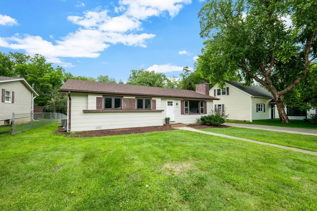 a front view of house with a garden