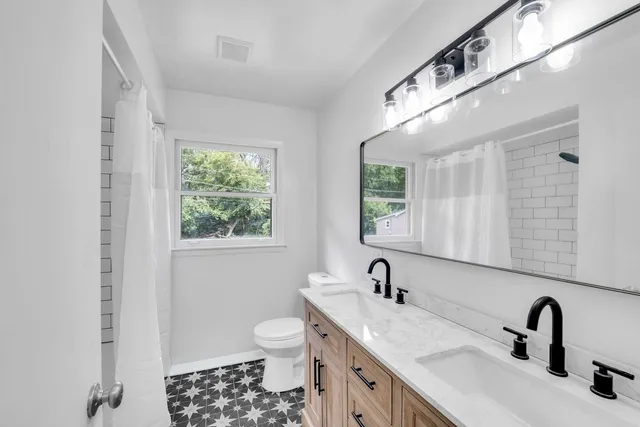 a bathroom with a sink and a large mirror