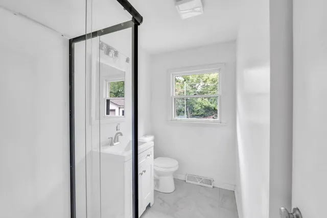 a bathroom with a glass shower door
