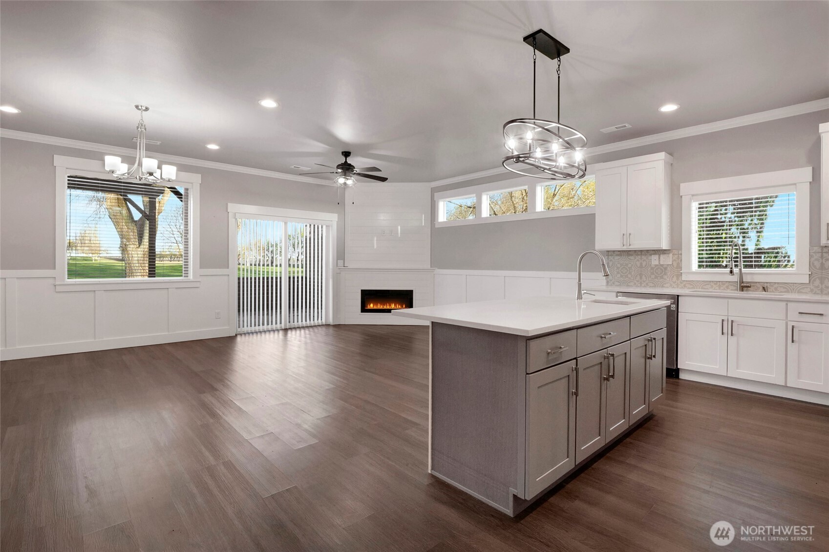1213 Rd F .2 Northeast, Unit A&B Moses Lake, WA 98837 - Photo 12 of 37 a large white kitchen with kitchen island white cabinets and wooden floor