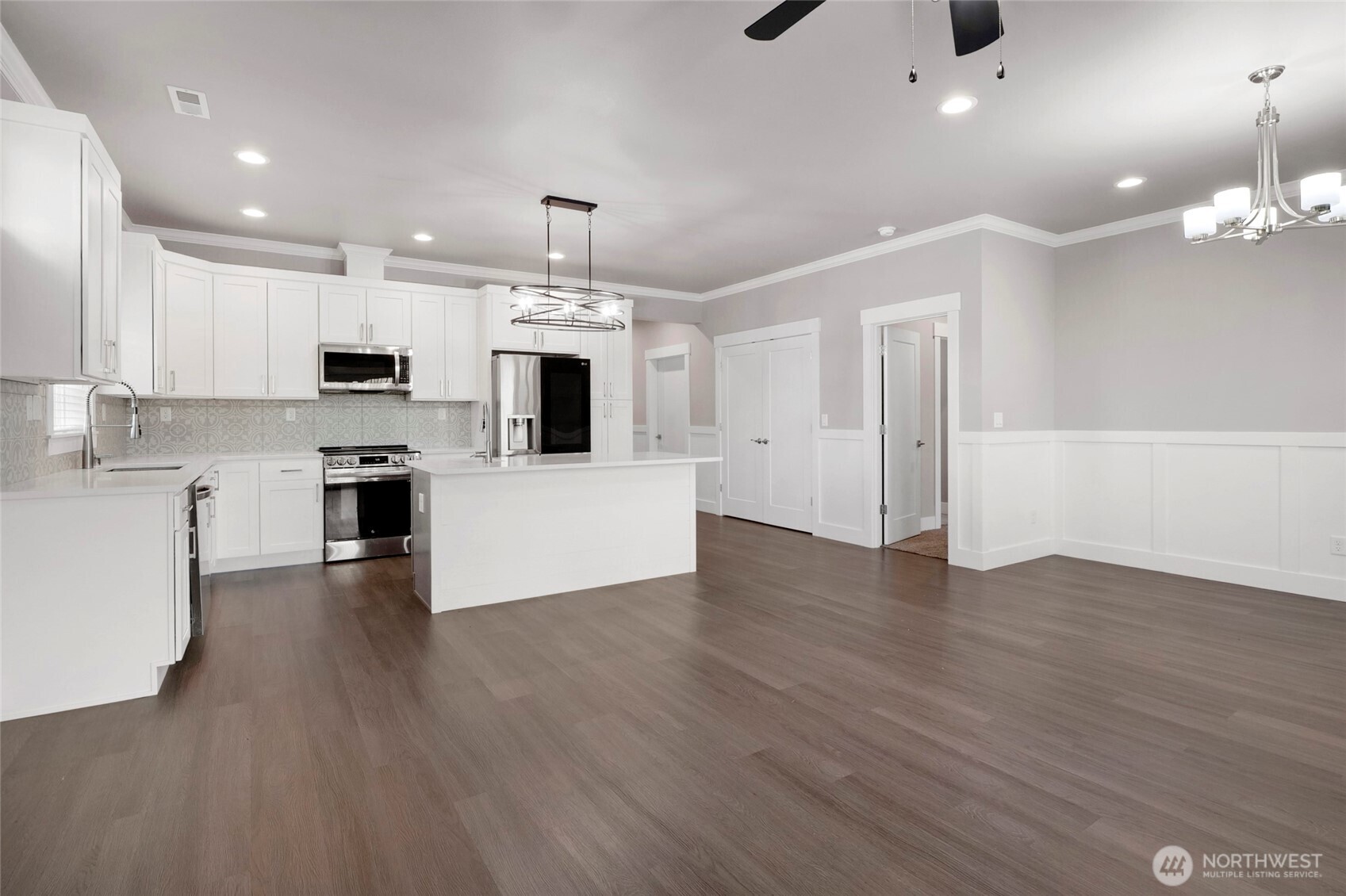 1213 Rd F .2 Northeast, Unit A&B Moses Lake, WA 98837 - Photo 15 of 37 a large kitchen with cabinets wooden floor and stainless steel appliances
