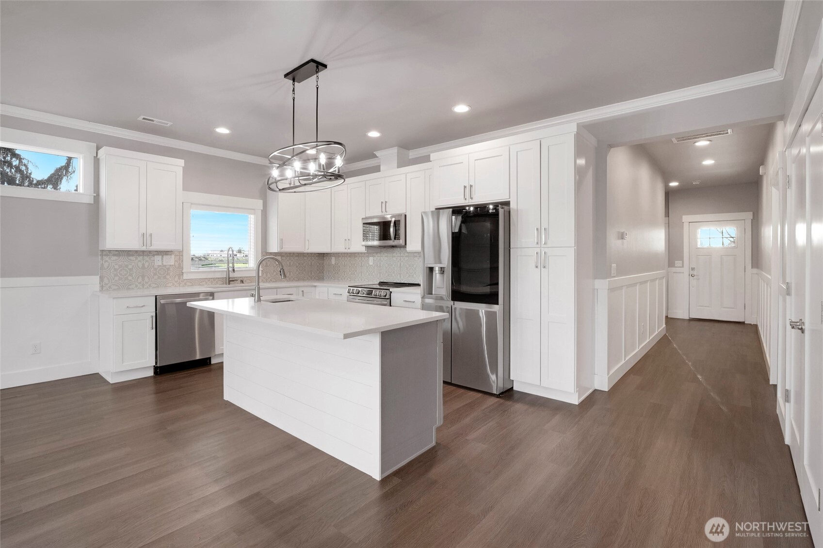 1213 Rd F .2 Northeast, Unit A&B Moses Lake, WA 98837 - Photo 16 of 37 a kitchen with kitchen island white cabinets and stainless steel appliances