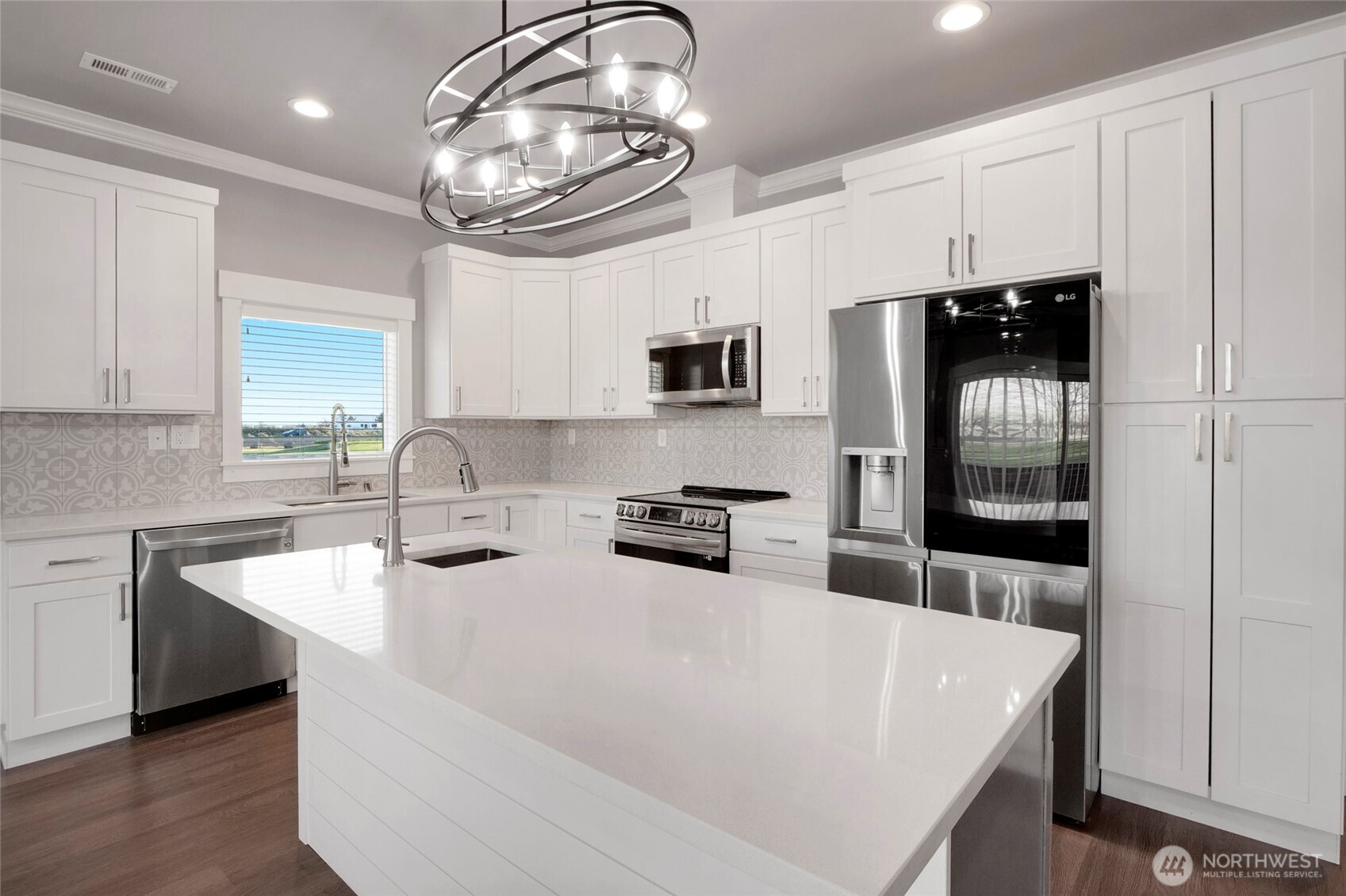 1213 Rd F .2 Northeast, Unit A&B Moses Lake, WA 98837 - Photo 17 of 37 a kitchen with stainless steel appliances a sink a stove a refrigerator cabinets and a window