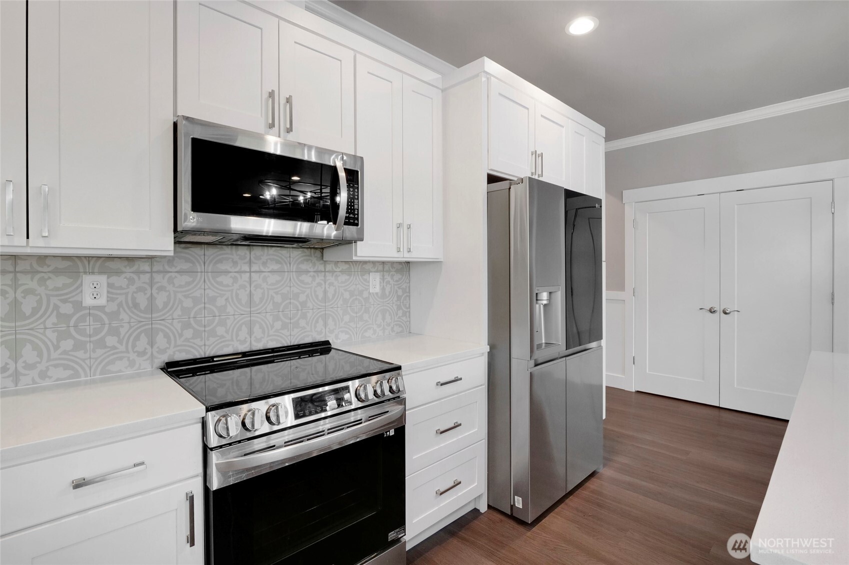 1213 Rd F .2 Northeast, Unit A&B Moses Lake, WA 98837 - Photo 20 of 37 a kitchen with stainless steel appliances a white cabinet and a microwave