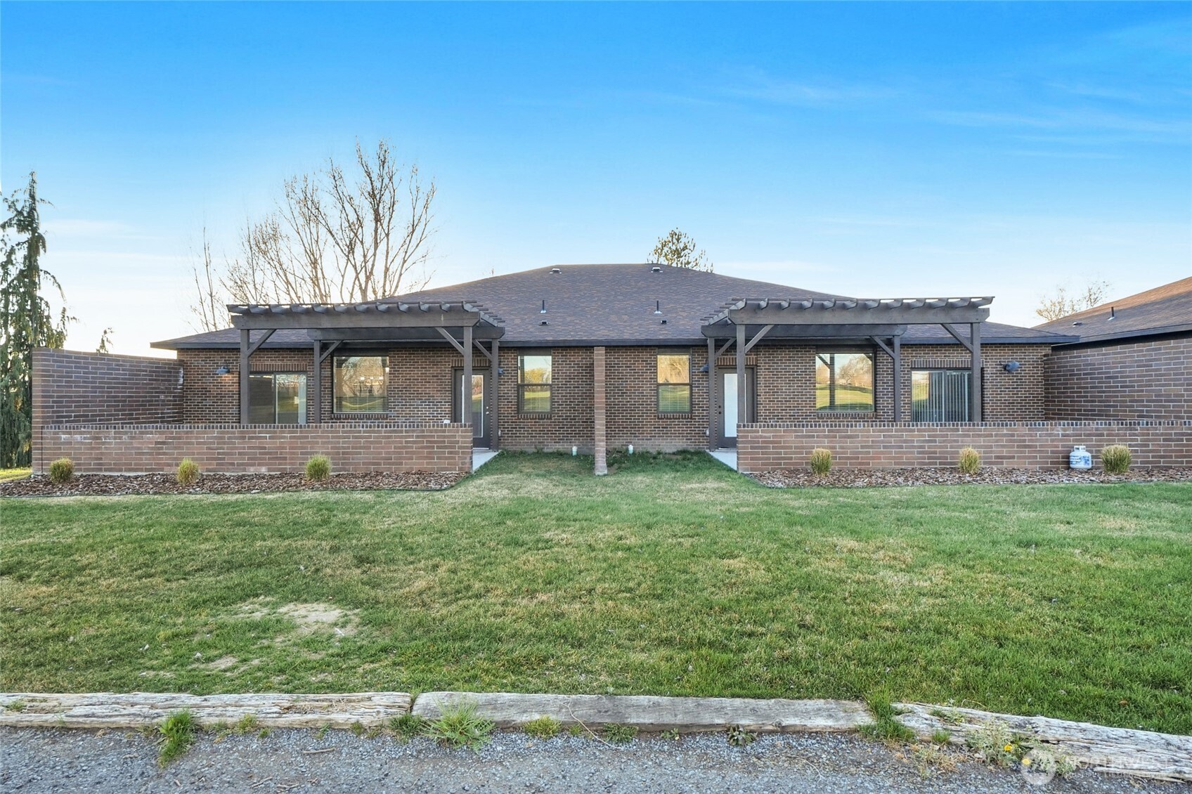 1213 Rd F .2 Northeast, Unit A&B Moses Lake, WA 98837 - Photo 36 of 37 a front view of a house with a garden