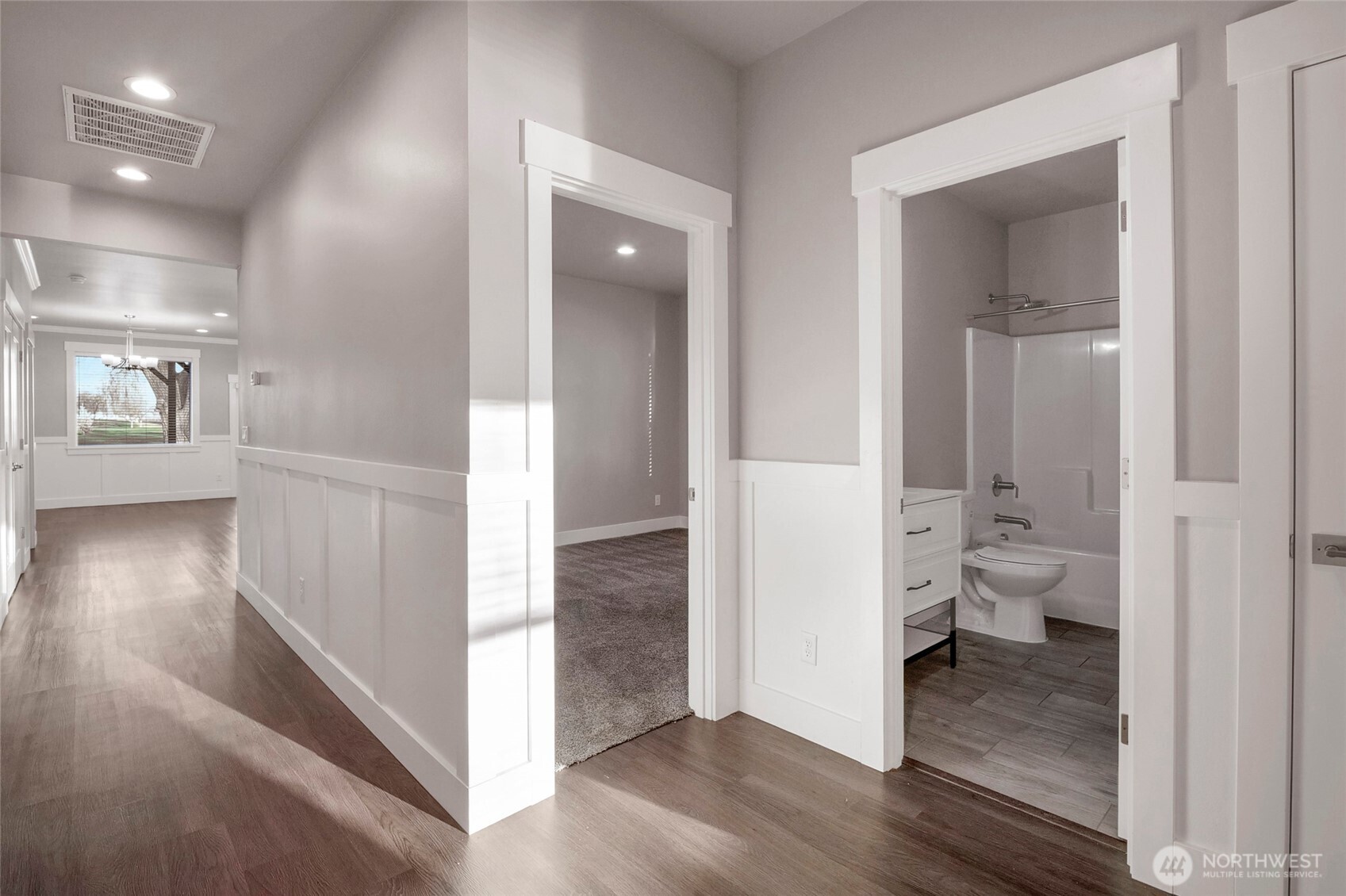 1213 Rd F .2 Northeast, Unit A&B Moses Lake, WA 98837 - Photo 10 of 37 a view of a hallway with wooden floor and a bathroom