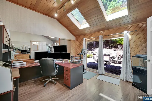 a view of a workspace with furniture and a window